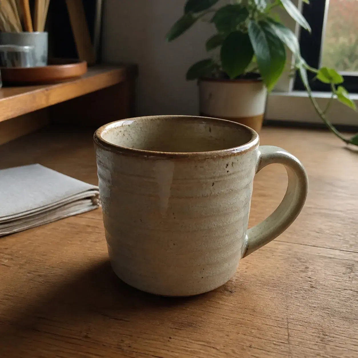 A real ceramic mug photographed at home